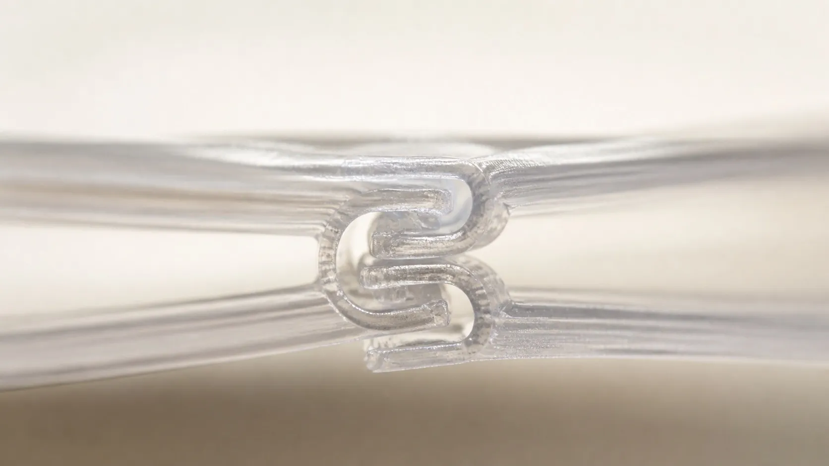 Two zipper profile tracks pressed together, showing how the ribs snap into each other